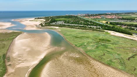 Lake-and-river-flowing-through-green-polder-landscape-at-Netherlands-and-Belgium-border,-Het-Zwin-nature-reserve