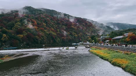 autumn scenery in japan with foggy mountains and river