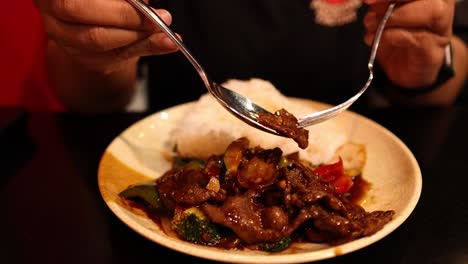 person enjoying stir-fried sweet and sour pork