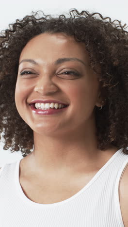 vertical video: smiling plus size woman in white tank top promoting body positivity
