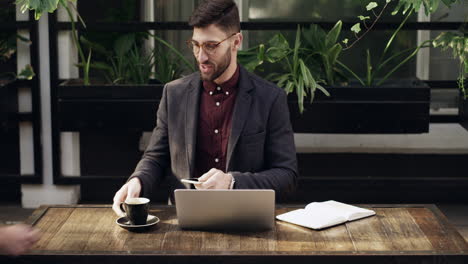 a young man getting served coffee while using