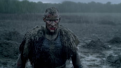 intense warrior in rain and mud