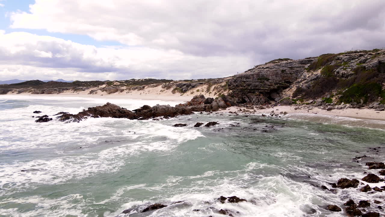 Drone flight over walkway and through ancient Klipgat Cave in Walker Bay reserve