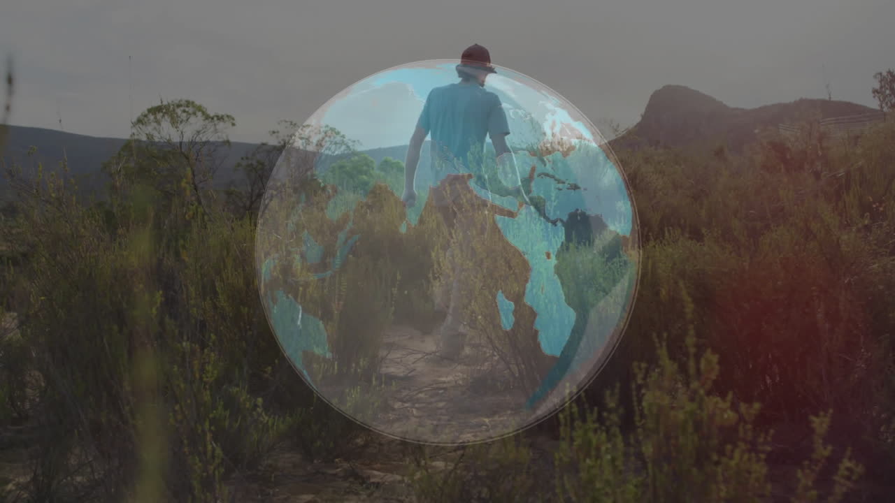 man walking along desert trail, showcasing technology concept with semi-transparent globe overlay