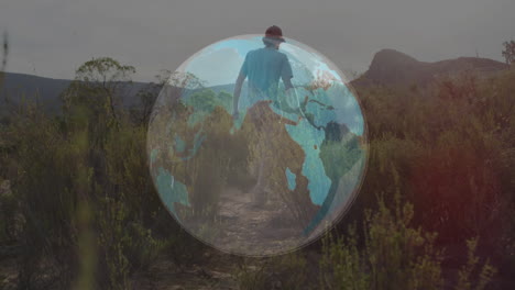 man walking along desert trail, showcasing technology concept with semi-transparent globe overlay