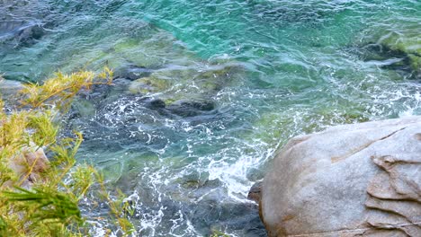 ocean waves hitting rocks in phuket, thailand