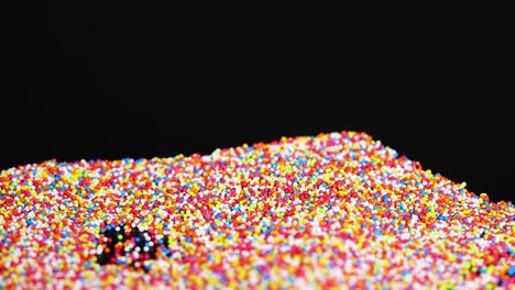 vibrant sprinkles cascade and settle in layers