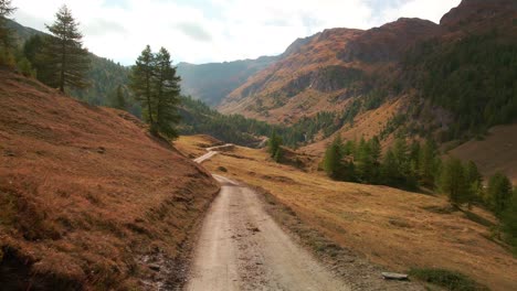 Empty-Dirt-Road-With-Mountain-Alps-In-Background-At-Argentera-Valley,-Cuneo-Province,-Piedmont,-Italy