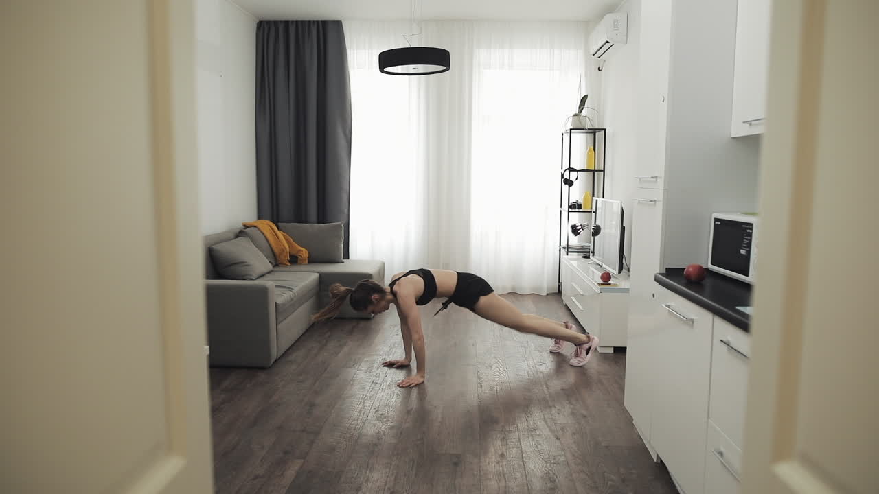Woman exercising in living room at home
