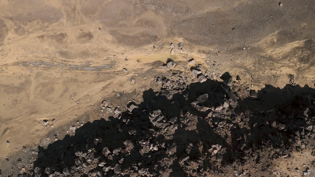 Aerial View of Volcanic Landscape with Dry Streambed and Rocky Outcrops