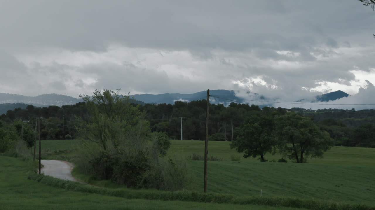 4K Timelapse of the fast movement of the clouds above the landscape of a small town in Spain