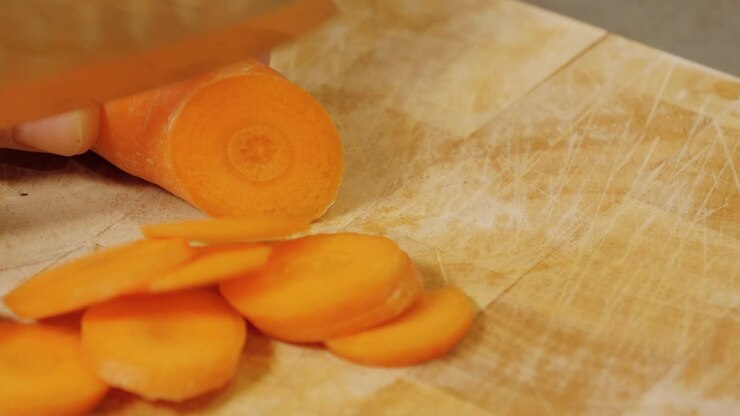 Motion controlled slow motion shot of cutting a carrot