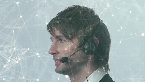 Animation-of-network-of-connections-over-businessman-using-phone-headset