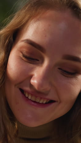 surprised positive lady with long flowing blonde hair in warm polo neck sweater nods on blurred background in light room closeup slow motion