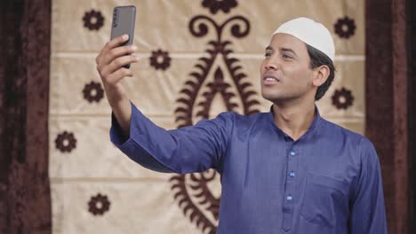 happy muslim man talking on a video call