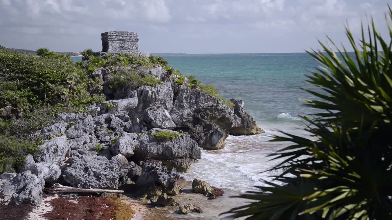 Bay view with ocean of Tulum ruins with palm trees, Mexico