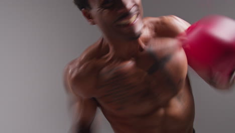 Real-Time-Studio-POV-Shot-Of-Tattooed-Male-Boxer-Wearing-Boxing-Gloves-In-Boxing-Match-Punching-Towards-Camera-1