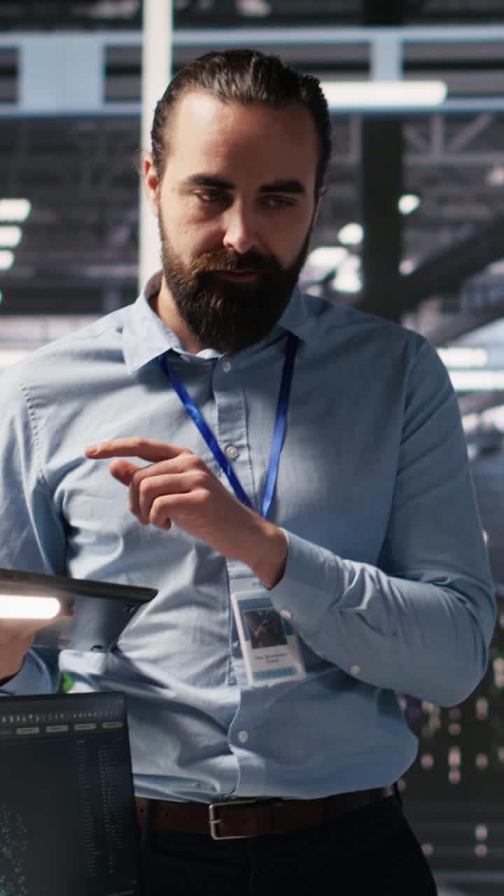 Vertical video Annoyed data center employee making rude hand gesture toward colleague