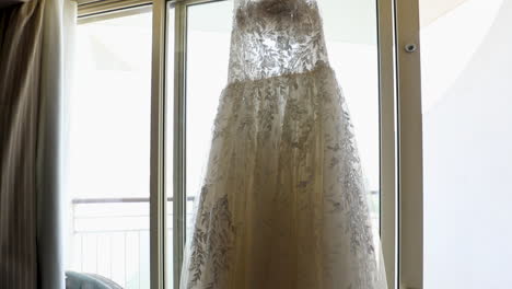 The-bride's-dress-hanging-on-the-window-in-the-morning---push-out