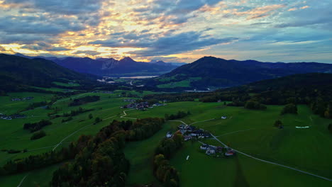 scenic aerial sunset view with vibrant illuminated clouds over attersee, austria