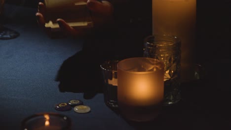 close up of woman laying out cards for tarot reading on candlelit table 1