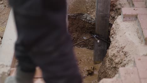 watering the soil on the support poles when installing paving blocks