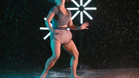 pretty caucasian female dancer spinning in the rain, modern dance