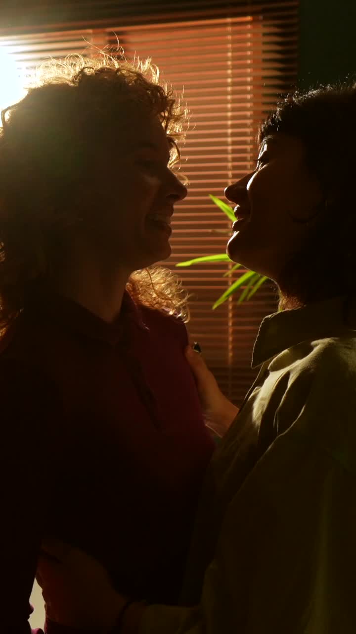 Affectionate women in kitchen setting