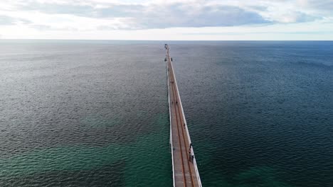 drone flying along the famous busselton jetty in margaret river, western australia