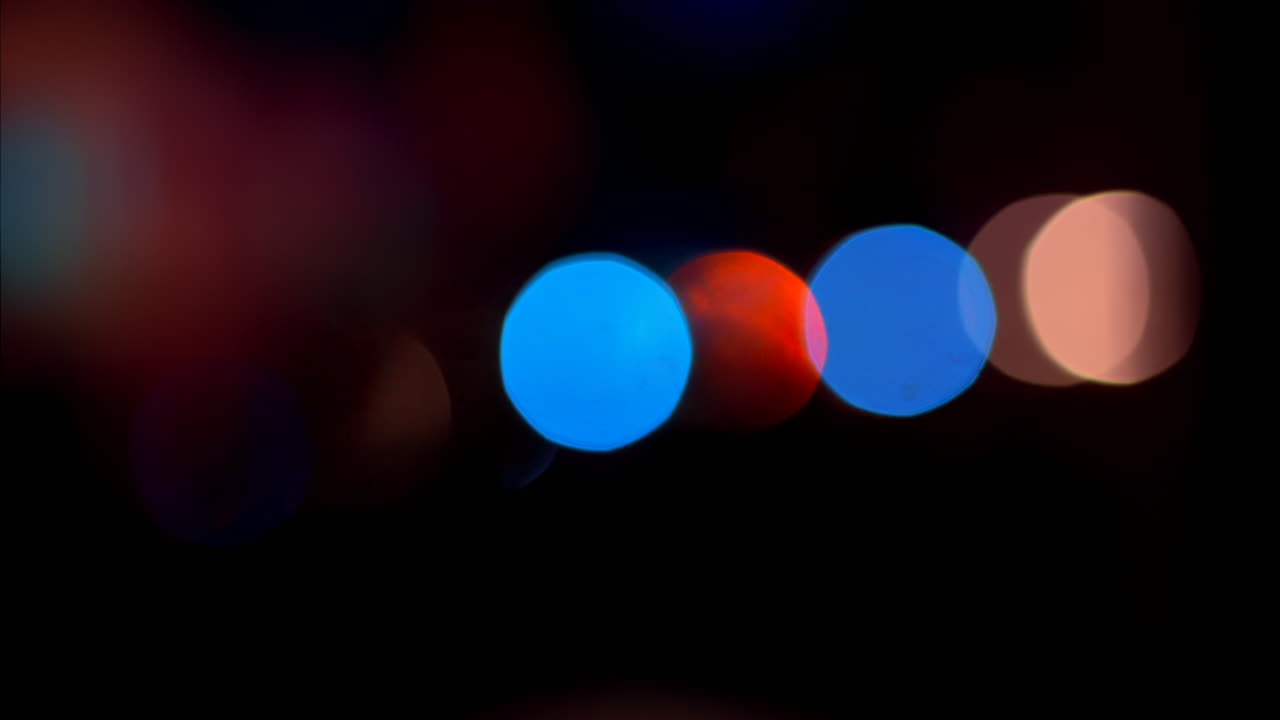 Abstract display of out-of-focus, colourful lights in a dark setting