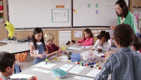 teacher and young kids use blocks in class, shot on r3d