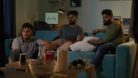 friends watching tv and gaming at home at night