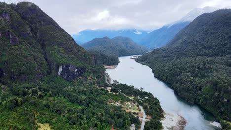 aerial view truck right of tagua tagua lake between its snowy and cloudy mountains, southern chile