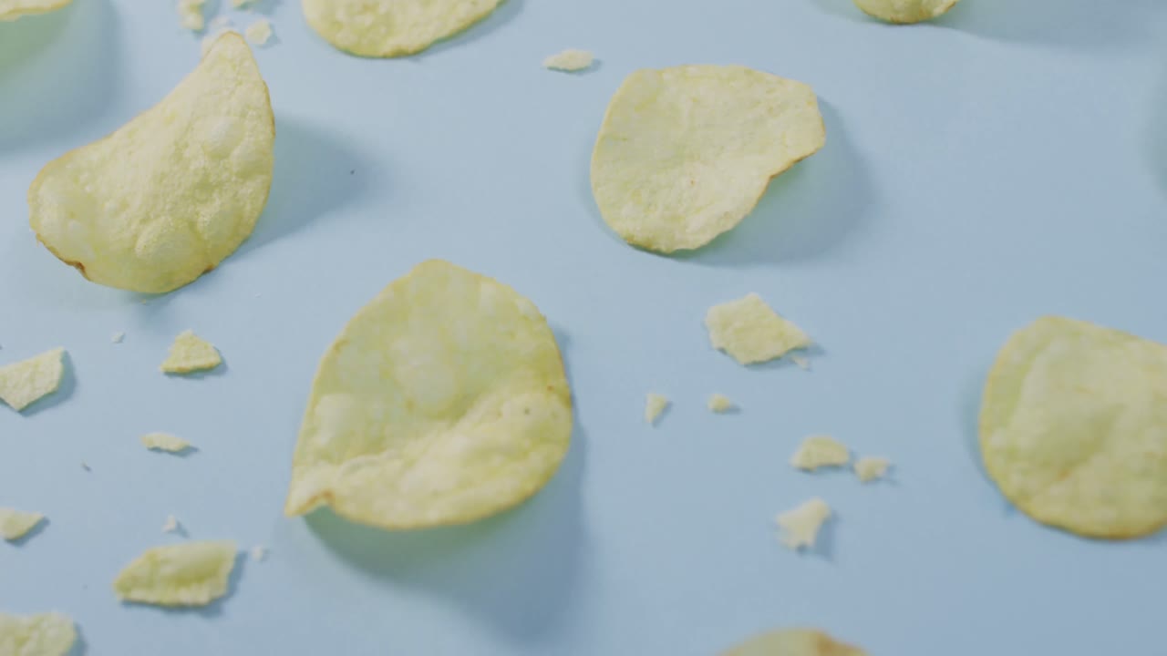 Close up of potato chips with copy space on blue surface