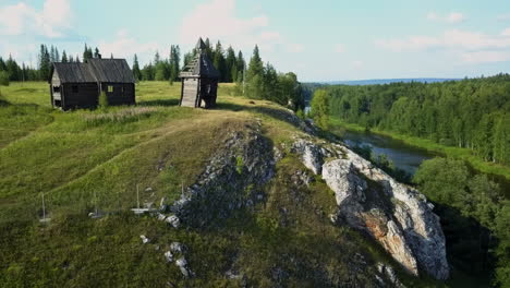 rustic river valley with wooden structures and boats