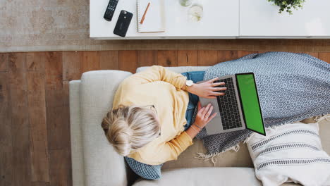 Overhead-Time-Lapse-Sequence-Of-Female-Social-Media-Influencer-Working-And-Relaxing-On-Sofa