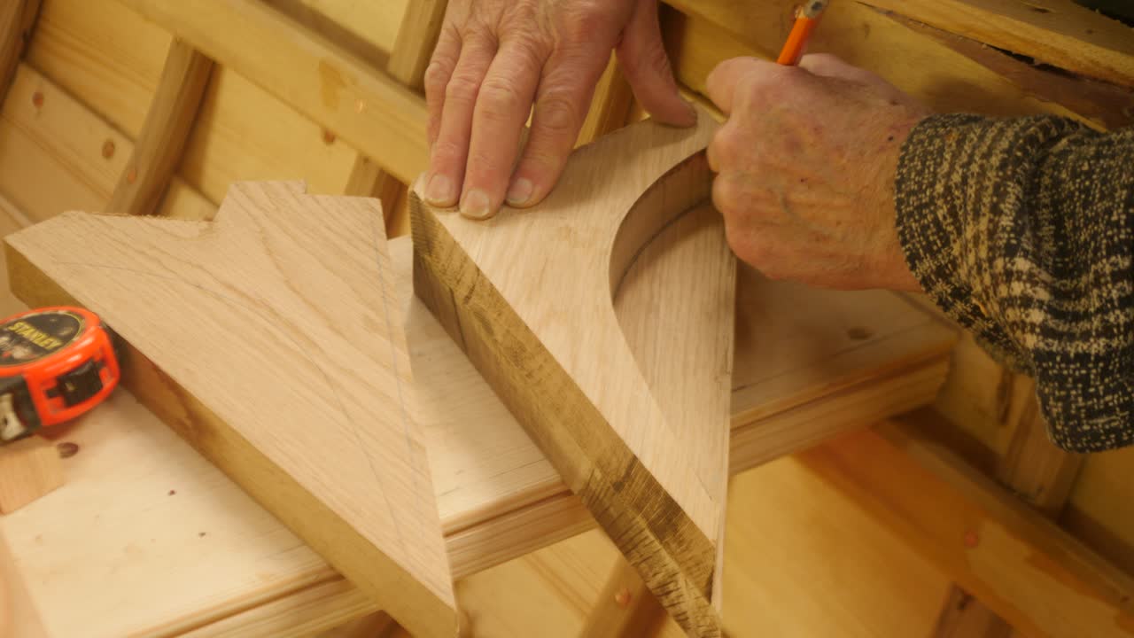 Skilled boatbuilder templating oak seat knee