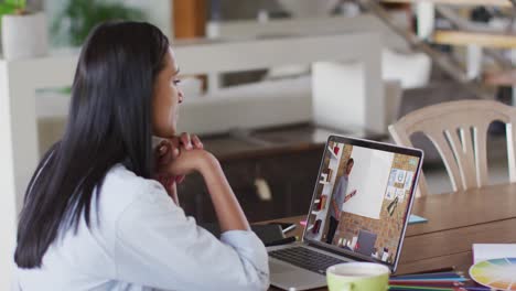 Caucasian-female-student-using-laptop-on-video-call-with-male-teacher