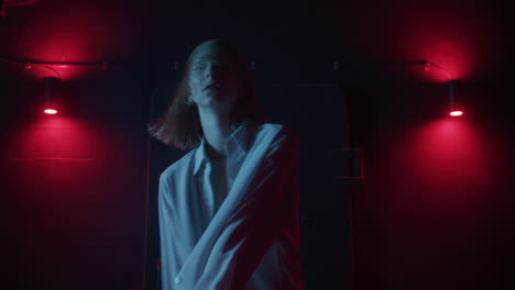 woman dancing in a night club under red and blue lights