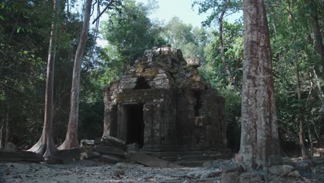 ancient temple ruins of angkor wat surrounded by jungle, stone structure with trees