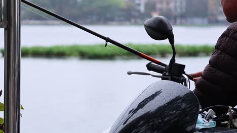 person fishing beside a lake in hanoi