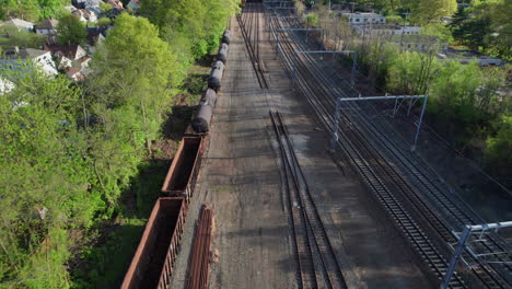 flying over an abandoned track with old wagons of the amtrak commuter line