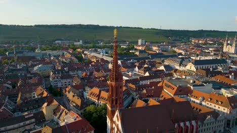 4k aerial drone video of the ornate steeple of st mary's chapel in downtown würzburg, germany