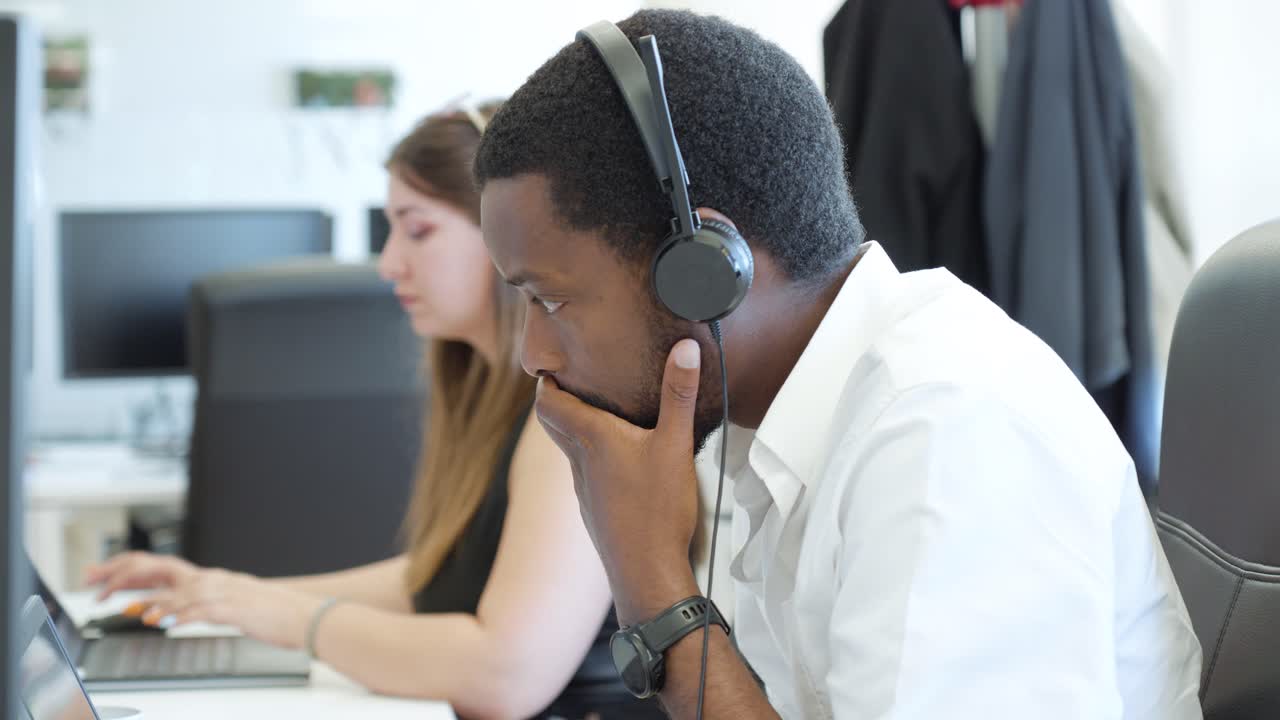 Two colleagues working attentively at their desks in a modern office