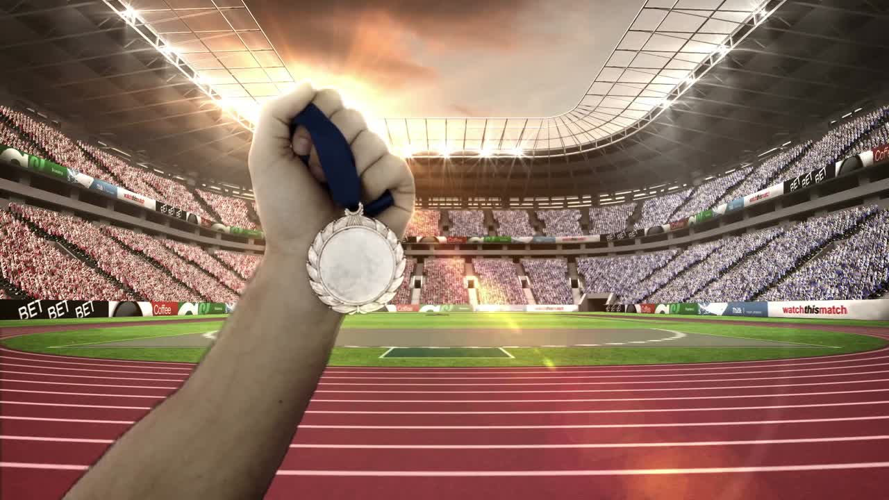mano de un atleta que muestra medallas de oro en el estadio olímpico
