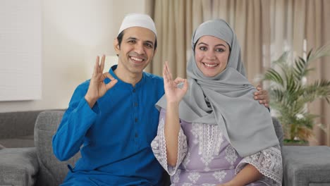 happy muslim couple showing okay sign