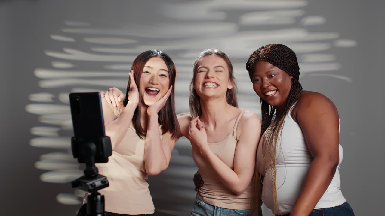 Diverse group of women taking selfies and having fun in the studio