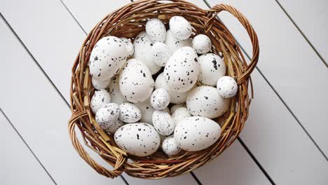 Basket-of-white-dotted-Easter-eggs-in-brown-wicker-basket
