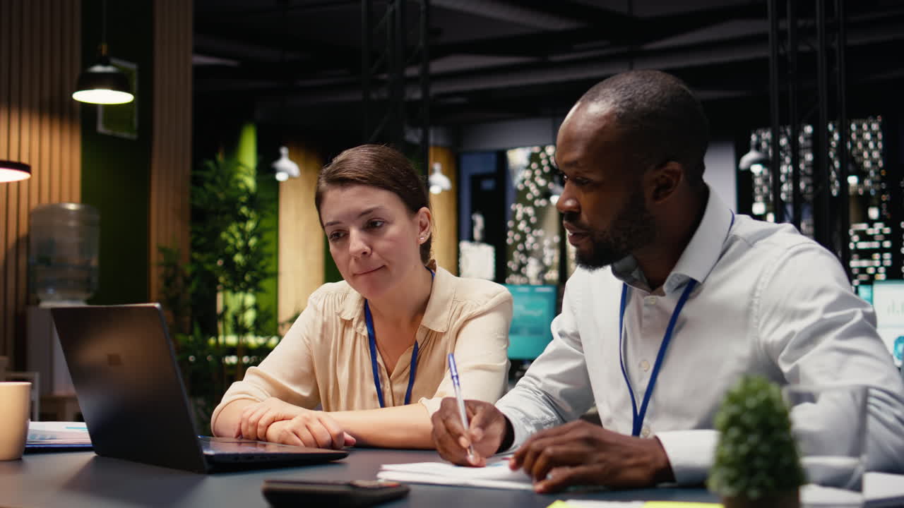 Office scene featuring partners working at night on company project