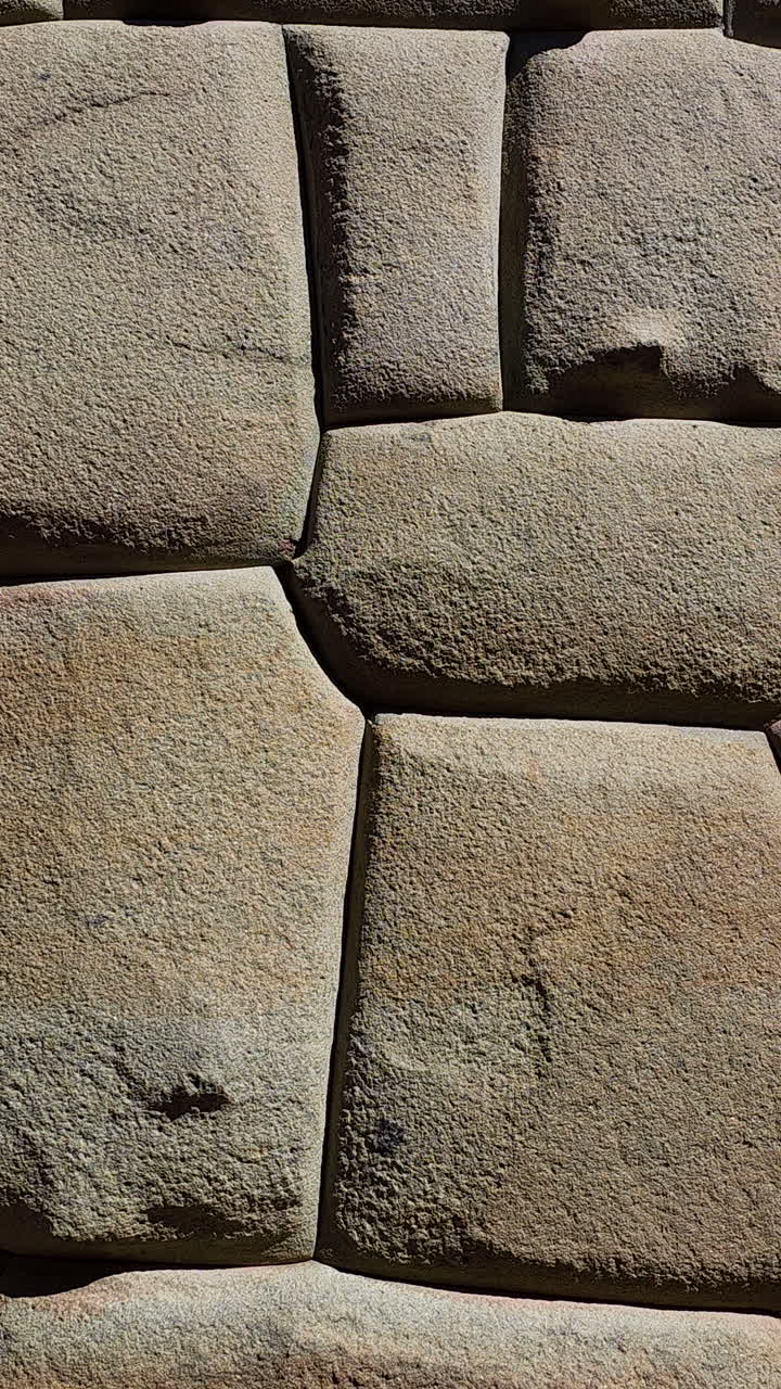 A close-up video showcasing the incredible detail and precision of a historic Inca wall in Cusco, Peru. The masterful stonework and interlocking, mortar-less construction of this ancient civilization